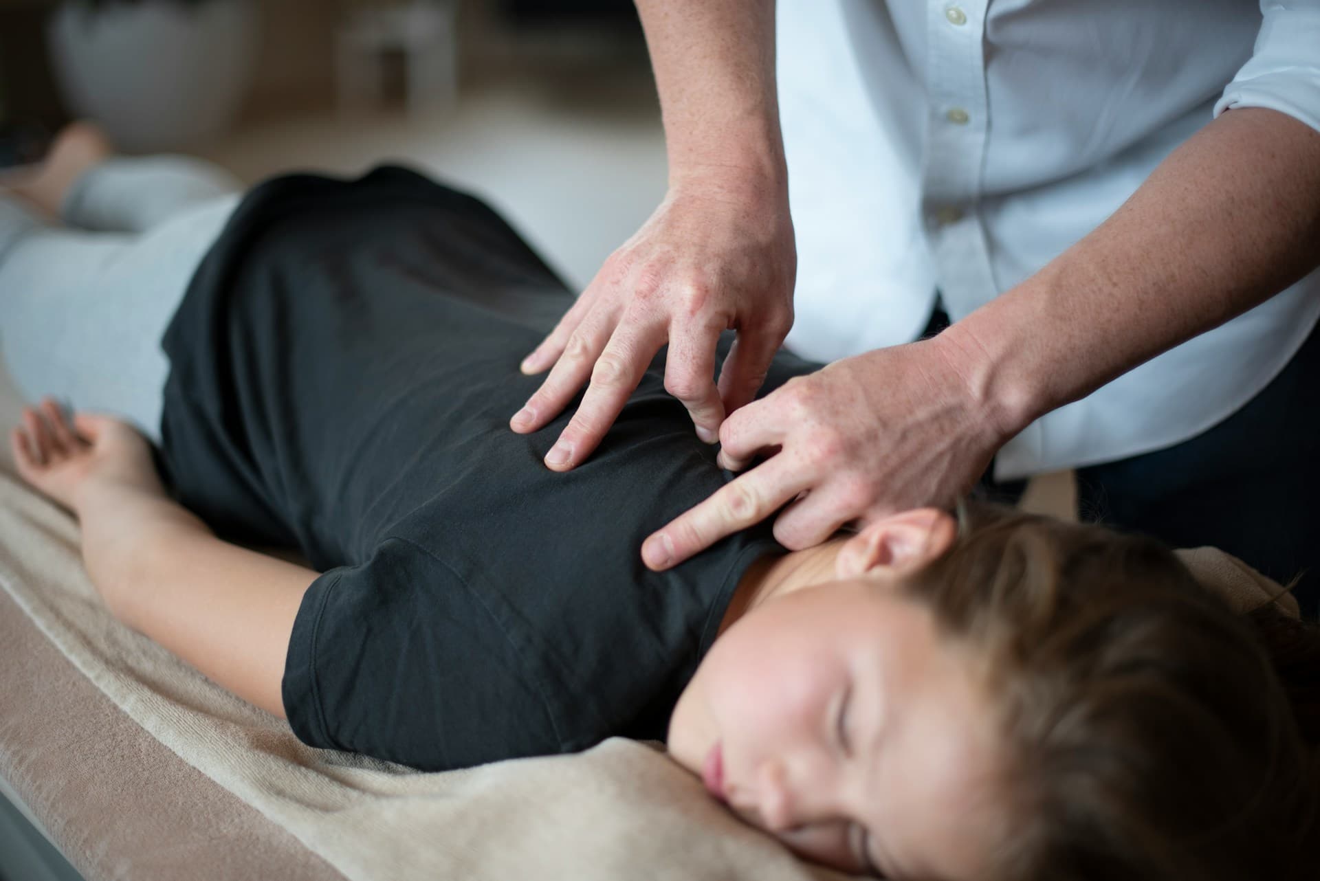 Pediatric chiropractor gently caring for a young child
